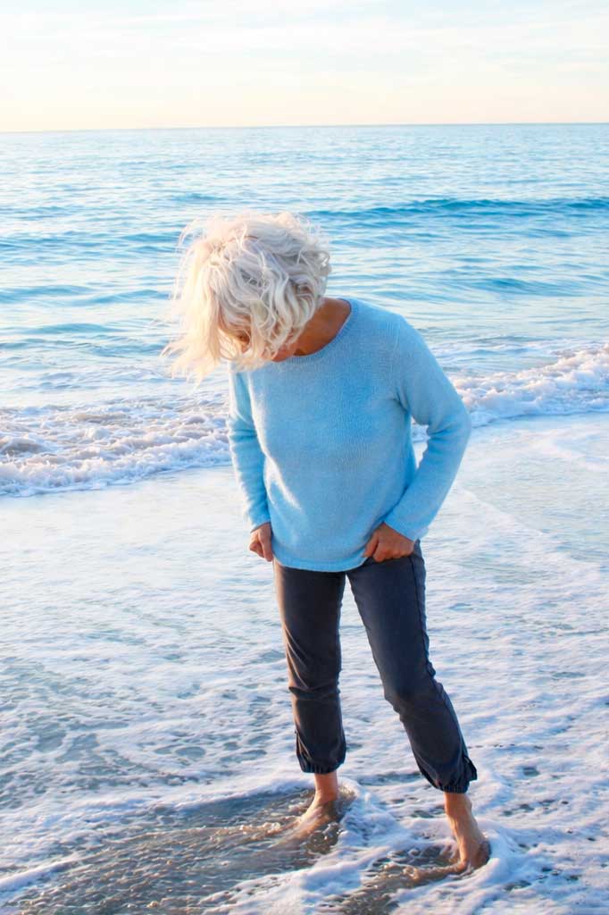 Woman playing in the water at the beaches shore.
